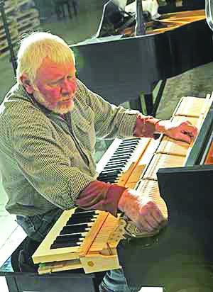 A Steinway professional assembles one of the pianos.