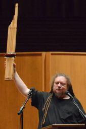 EQLS speaker, Jaron Lanier, holds up his khene, a traditional bamboo mouth organ from Laos. Lanier opened his presentation by playing this instrument that he compared to computers.