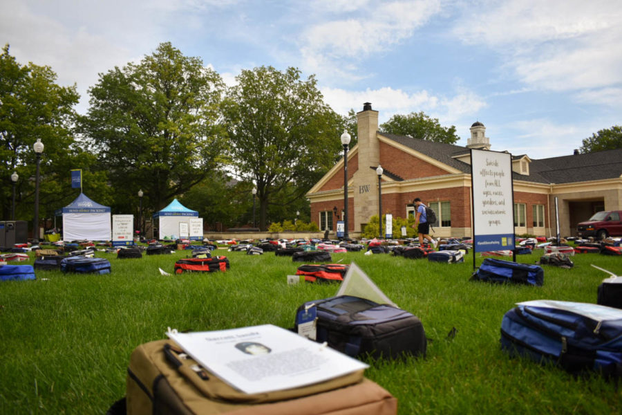 Suitcases spread out in front of Strosacker Hall 