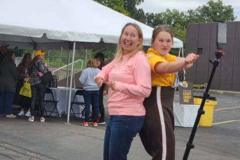 Meghan Kania, center left, and her daughter, Leah Kania, dance for the 360 cameras at the tailgate event held before attending the football game.