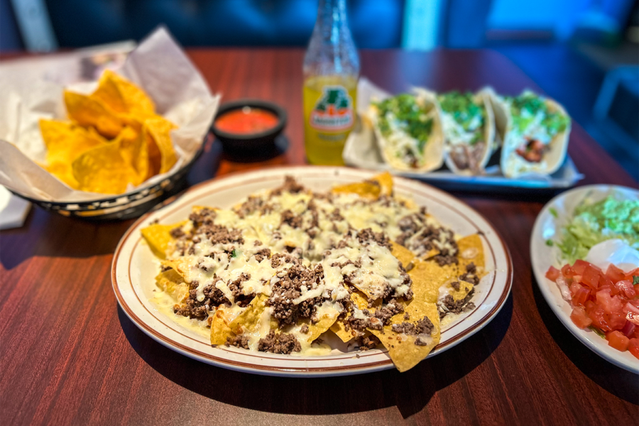 A picture depicting El Toritos Nachos, tacos and other various appetizers