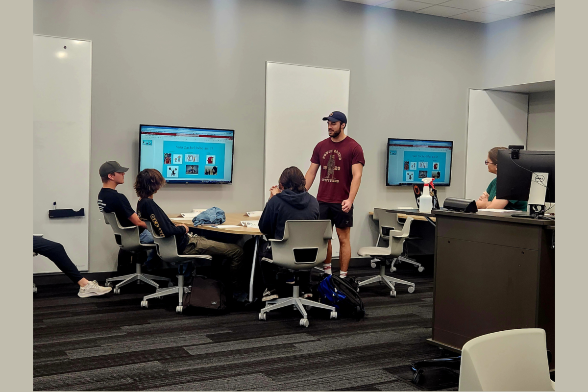 Sam Zachel presents his “Who am I?” presentation to his First Year Experience class taught by Catherine Lane, professor of mathematics, in the Knowlton Center. Students were tasked to create a slide to present their hobbies, background and fun facts.  