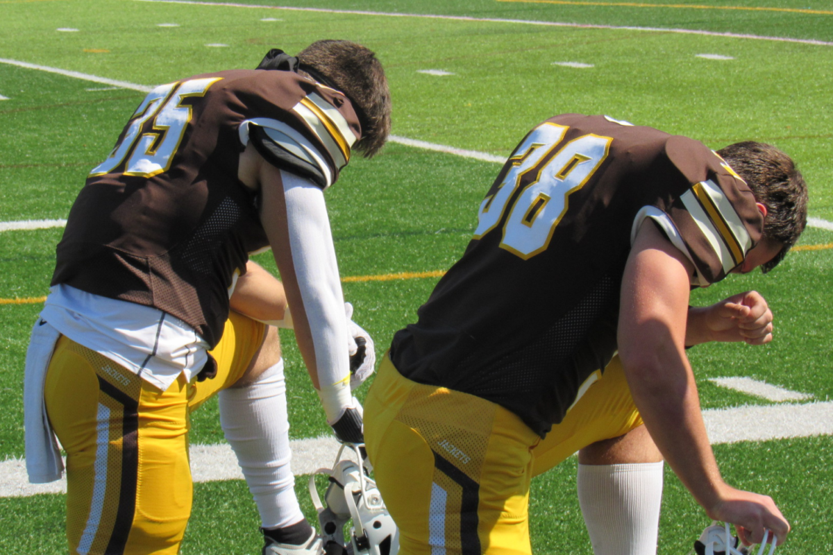 Players prepare for the Baldwin-Wallace Homecoming football game.