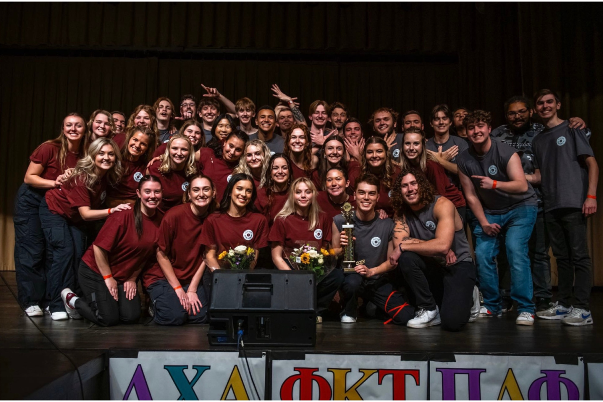 Winners+of+this+years+Greek+sing%2C+Alpha+Sigma+Phi+and+Delta+Zeta%2C+take+the+stage+with+their+trophy.+