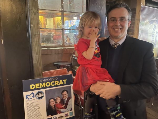 Ohio state representative candidate Chris Glassburn stands with his daughter at a fundraising event at Fat Little Buddies on March 14.