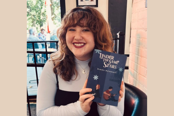 Brooke Balamenti holds up her new book "Under the Same Stars."