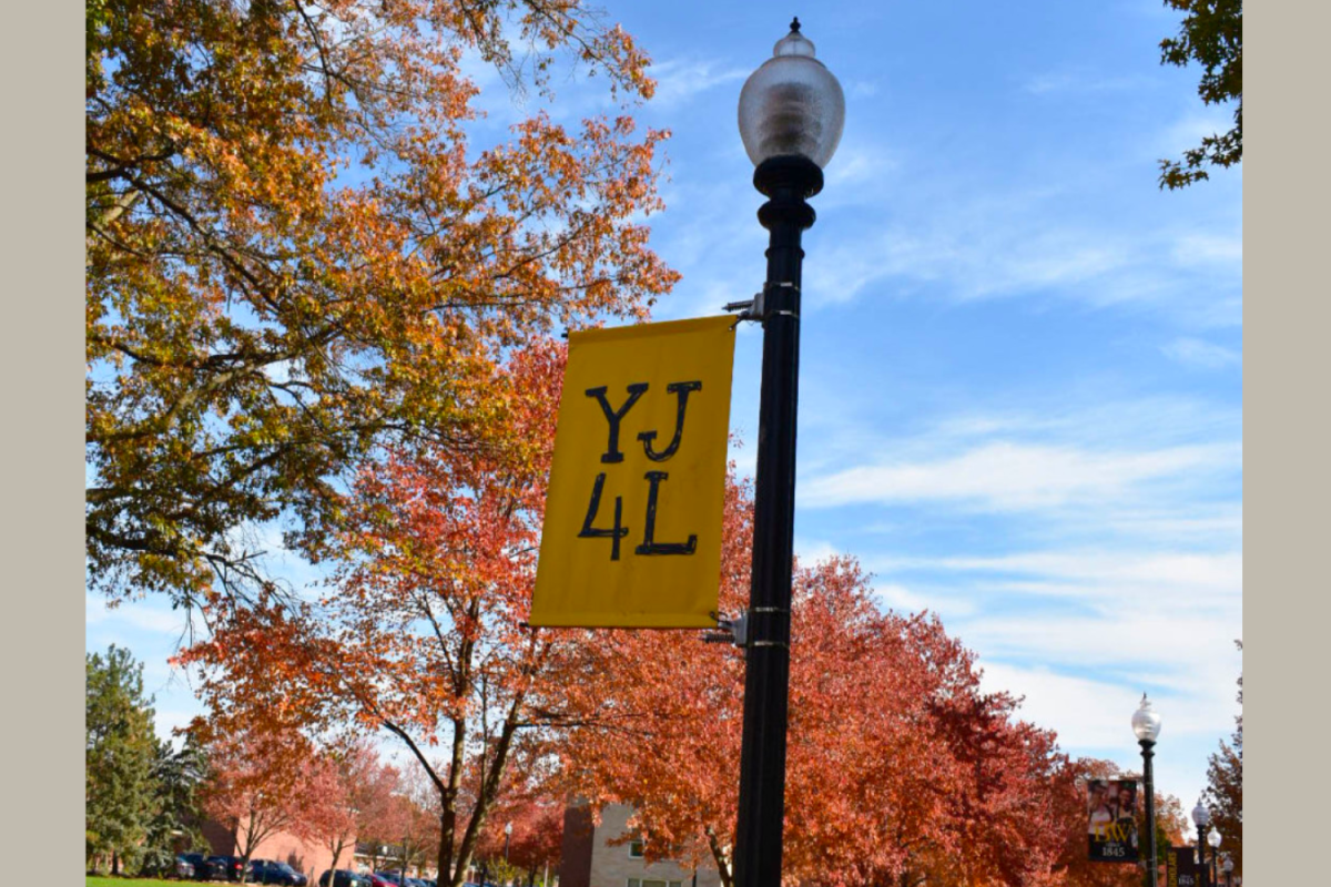 A photo of a YJ4L sign hanging from a lamppost. 