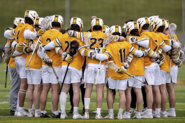 BW men's lacrosse team huddles together before a game.