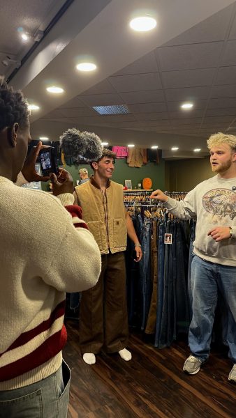 Jamar Worthy captures NIL footage of Harley Barmen and Noah Mowery at Mowery's business, The Thrifting Tree. Photo courtesy of Jakson Attanasio.