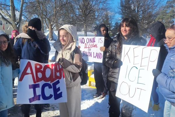 Students gather in front of Strosacker Hall, carrying signs in solidarity with ongoing protests in Minneapolis, MN.