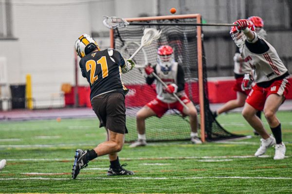 Senior Attack/Midfield Paxton Allison attempts a shot on goal during a scrimmage against Wittenberg University. Credit: Becky Grizovic